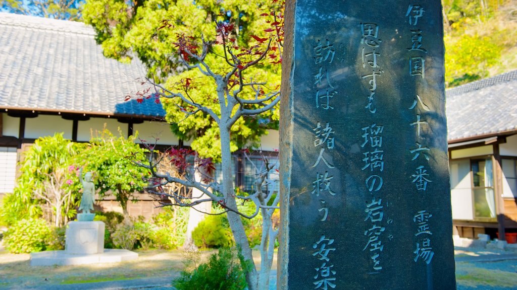 Anrakuji Temple featuring religious elements, a temple or place of worship and signage