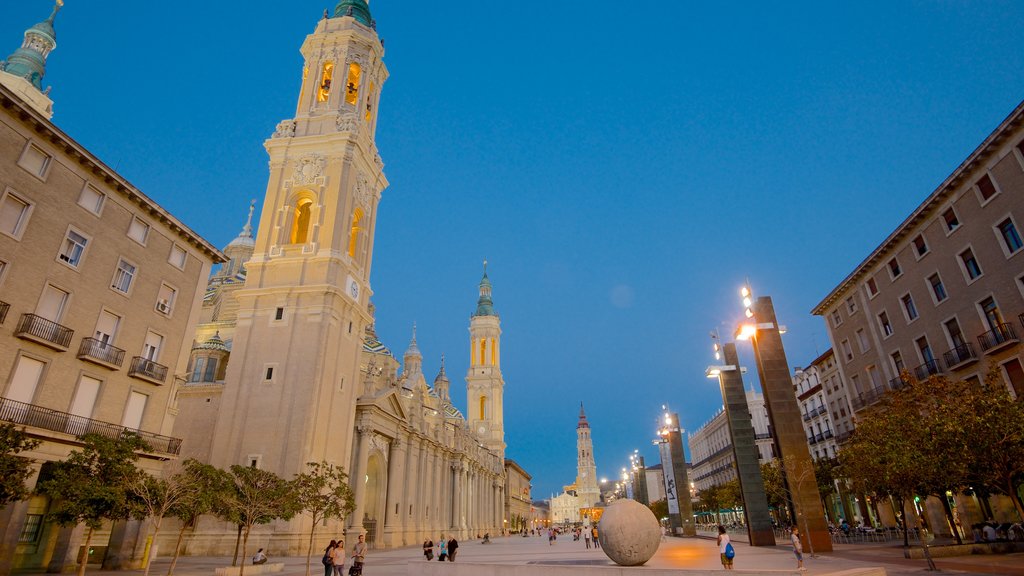 Plaza del Pilar which includes a church or cathedral, night scenes and heritage architecture