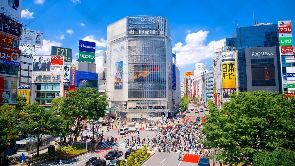 Shibuya que incluye arquitectura moderna, un parque o plaza y señalización