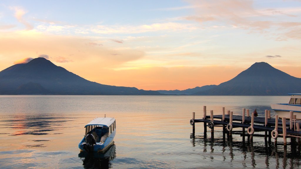 Lake Atitlan which includes a sunset, boating and a lake or waterhole