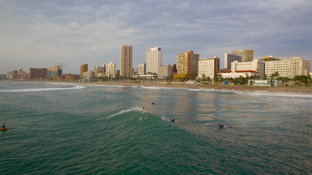 South Beach which includes surfing, skyline and a skyscraper