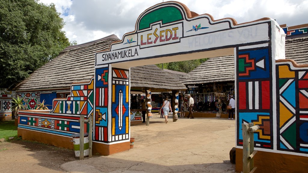 Lesedi Cultural Village showing a small town or village and signage