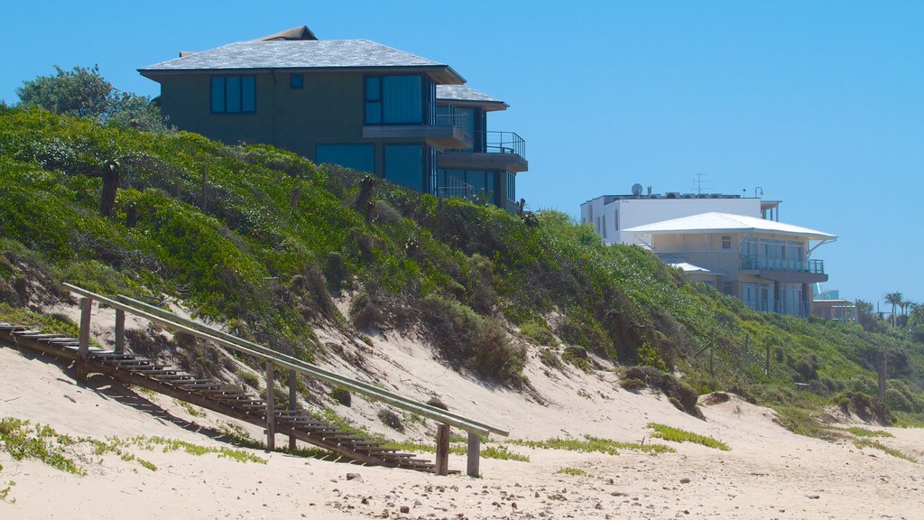 Dolphin Beach which includes a sandy beach, a coastal town and a house