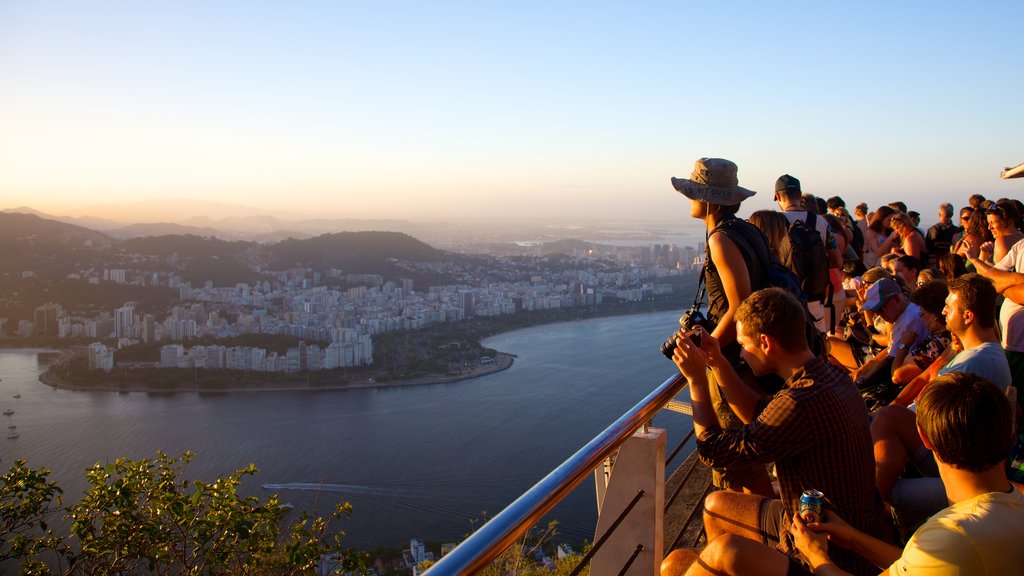 Sugar Loaf Mountain which includes a city and views as well as a large group of people