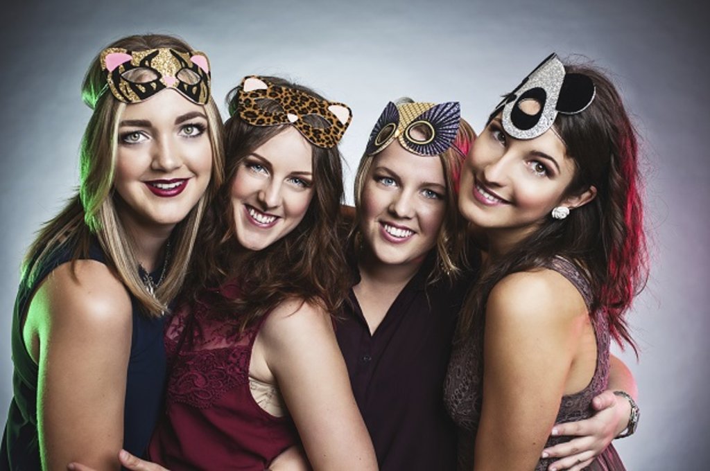 A group of friends wearing fancy dress masks