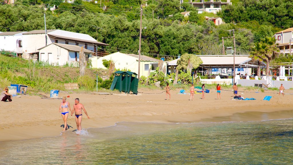 Pelekas Beach showing a sandy beach and a coastal town as well as a couple