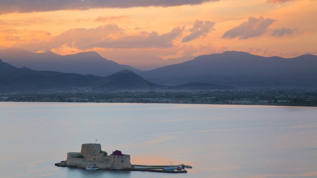 Castle of Bourtzi which includes a sunset, landscape views and a monument