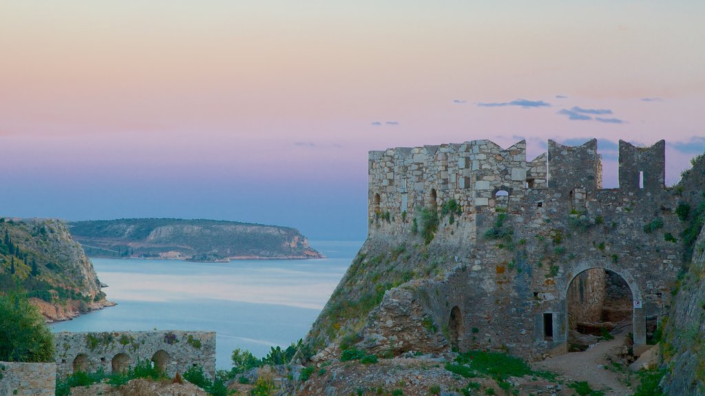 Acronafplia featuring a coastal town, rocky coastline and a sunset