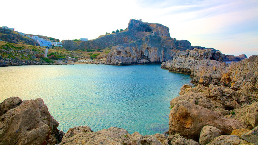 Rhodes Island showing a bay or harbour and rocky coastline