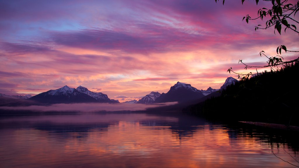 Glacier National Park which includes a sunset and a lake or waterhole