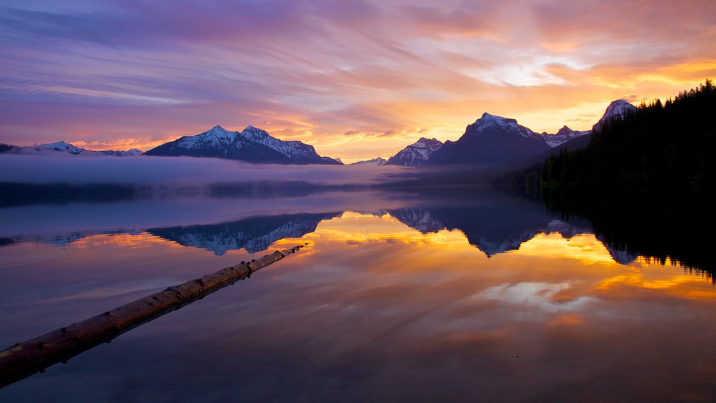 Glacier National Park which includes a lake or waterhole and a sunset