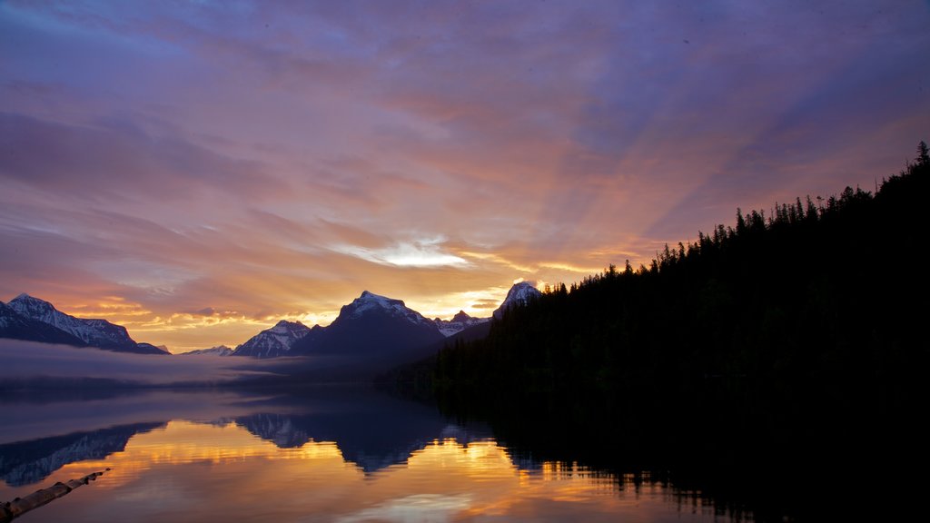 Glacier National Park which includes a sunset and a lake or waterhole