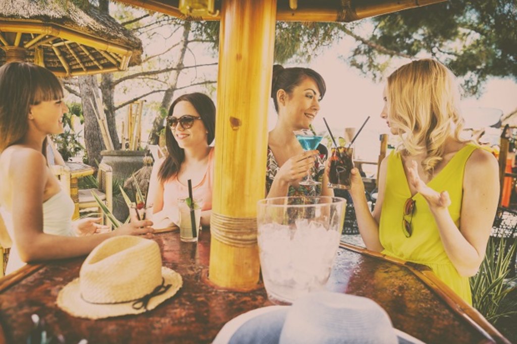 Girls enjoying a cocktail in the sun