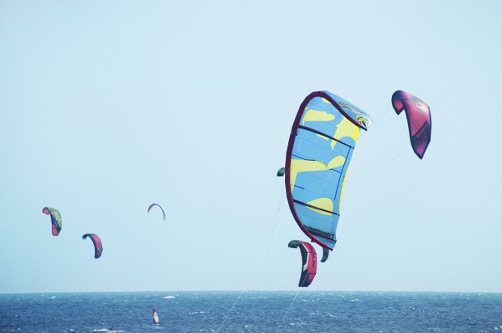 Kite surfing with an ocean background