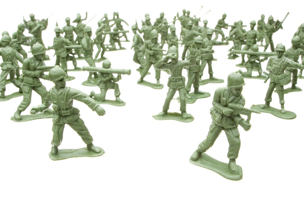 Green toy soldiers on white background 