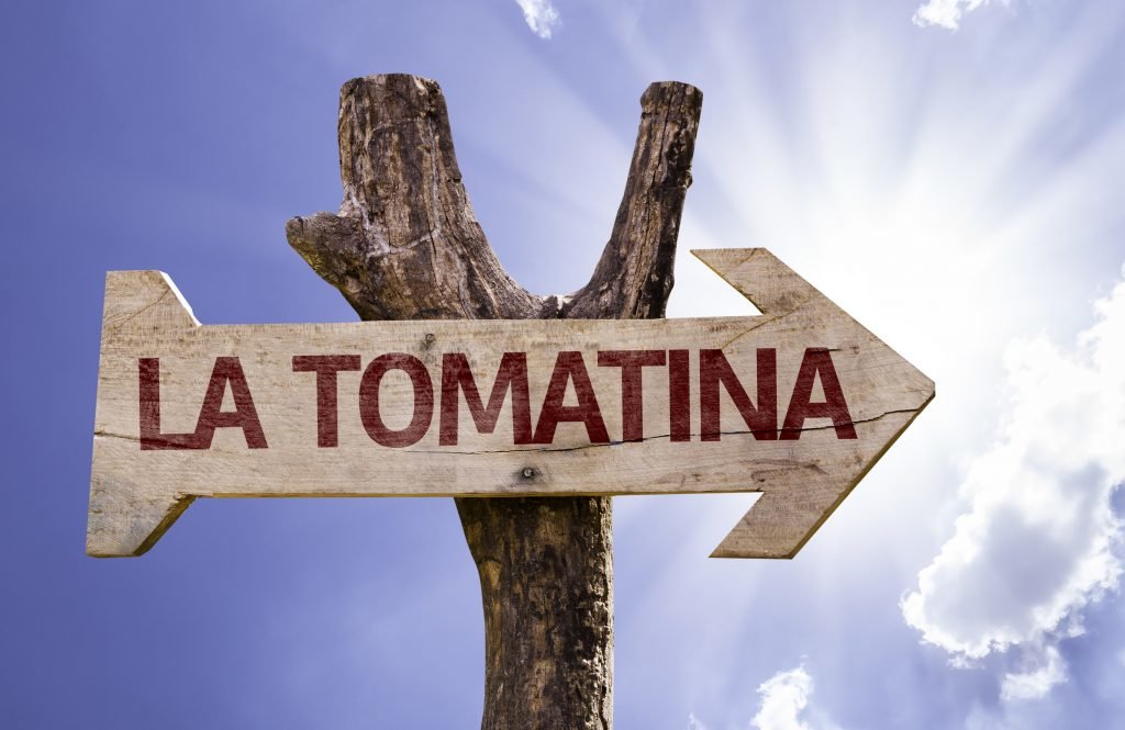 La Tomatina wooden sign on a beautiful day