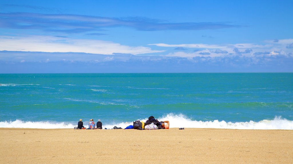 Grand Beach which includes general coastal views and a beach