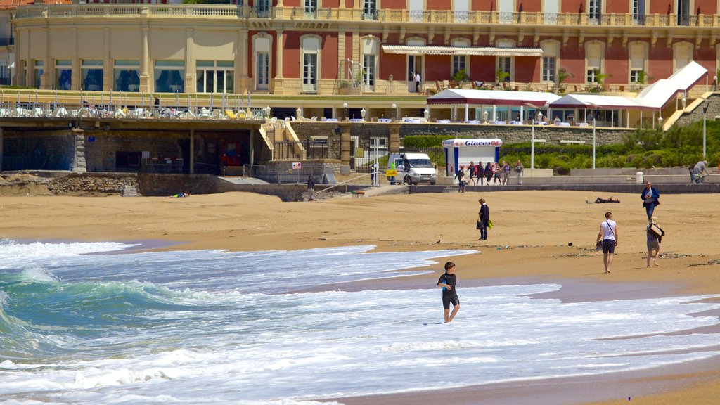 Grand Beach which includes a beach and a coastal town