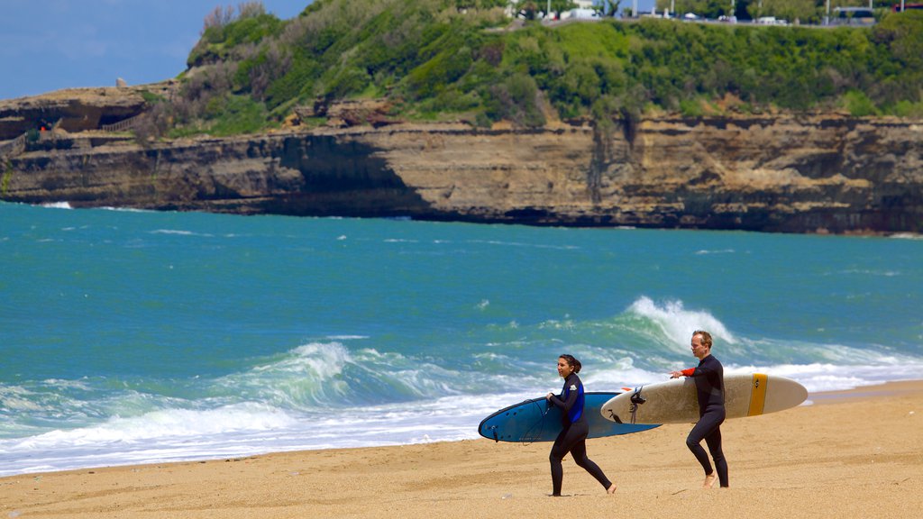 Grand Beach which includes rugged coastline, a sandy beach and surfing