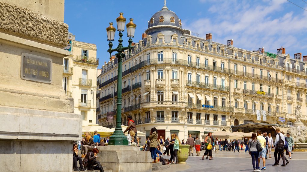 Place de la Comedie featuring street scenes as well as a large group of people