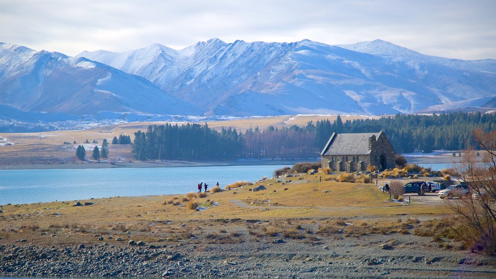 Church of the Good Shepherd featuring farmland, mountains and a lake or waterhole