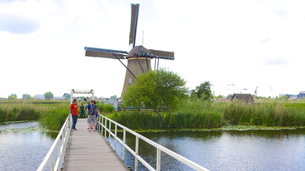 Kinderdijk which includes a windmill, a bridge and a river or creek