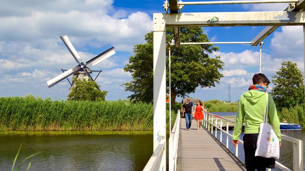 Kinderdijk featuring a windmill, wetlands and a river or creek