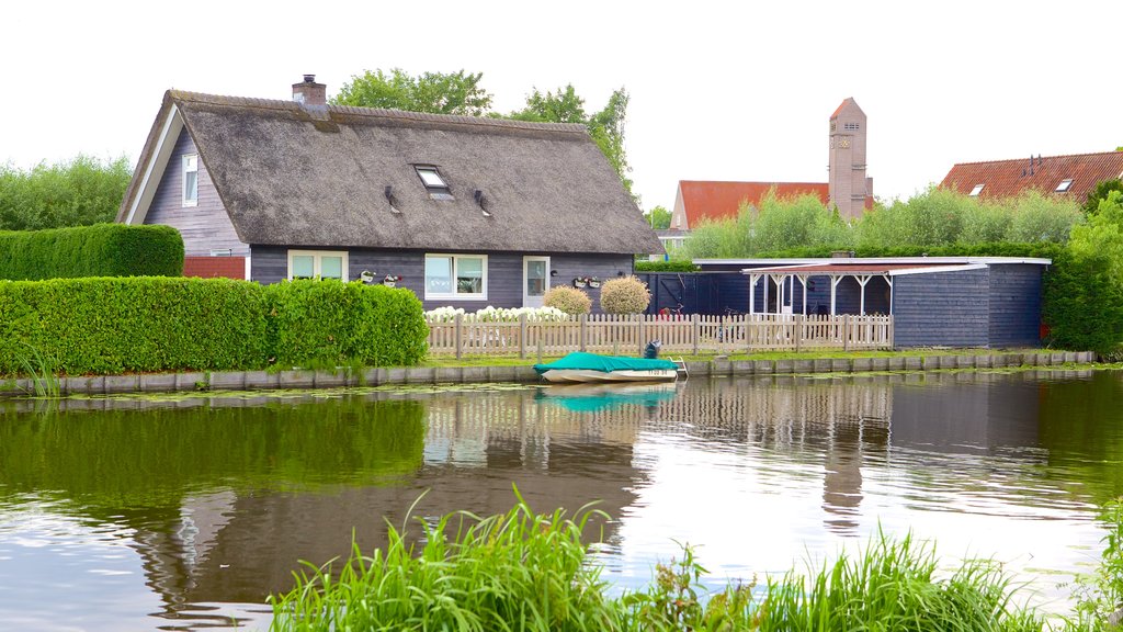 Kinderdijk featuring a house, farmland and a river or creek