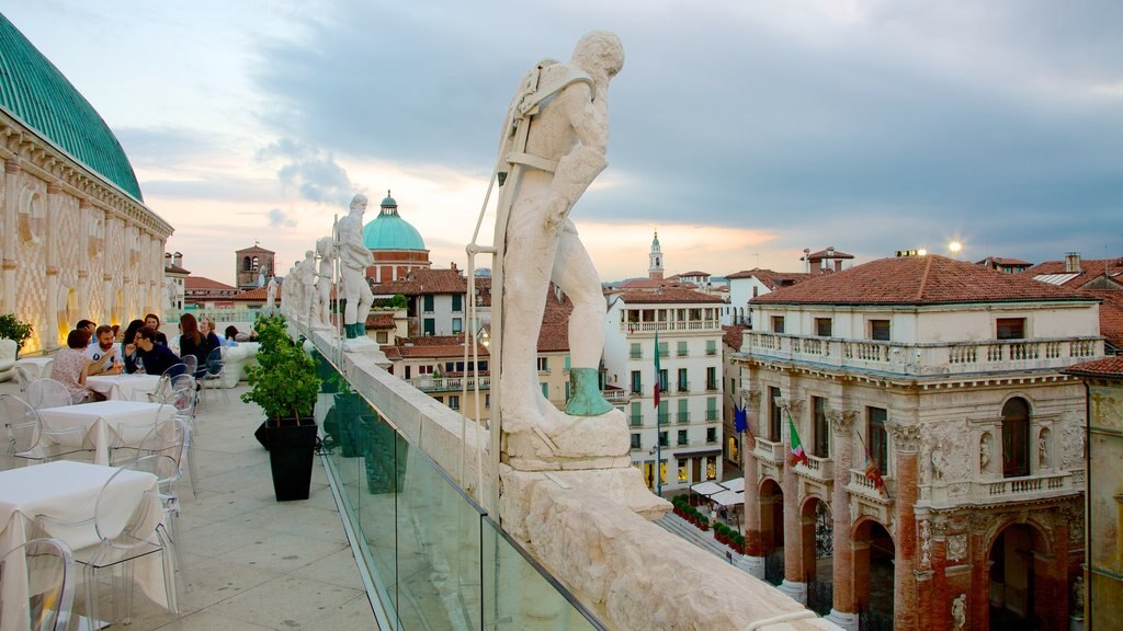 Piazza dei Signori showing outdoor eating, a city and a statue or sculpture