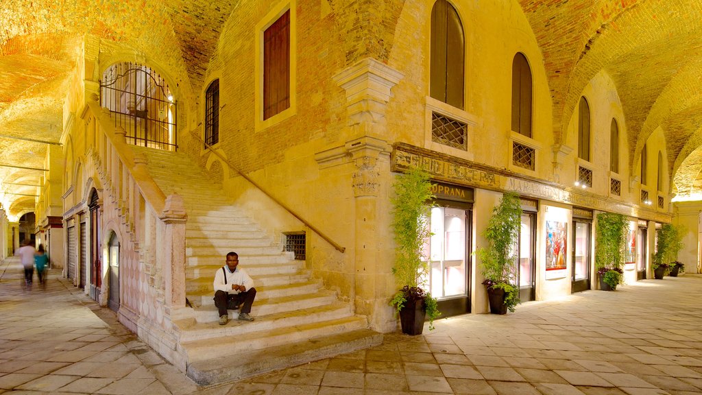 Piazza dei Signori featuring interior views and heritage architecture as well as an individual male