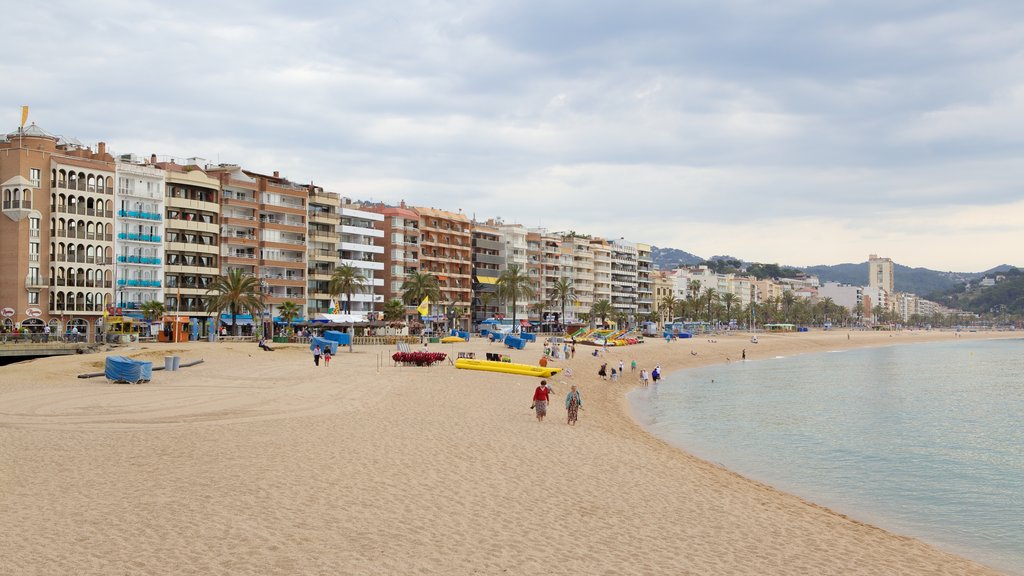 Costa Brava showing a coastal town and a beach