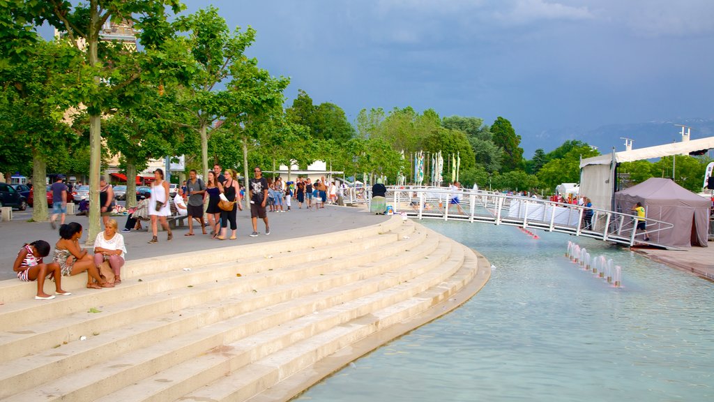 Lausanne showing a pond and a square or plaza as well as a large group of people