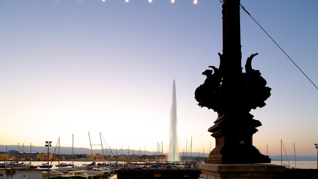 Jet d\'Eau Fountain showing a fountain, a marina and a sunset