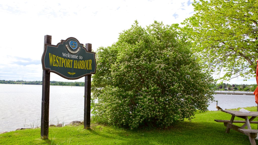 Westport which includes signage and a lake or waterhole