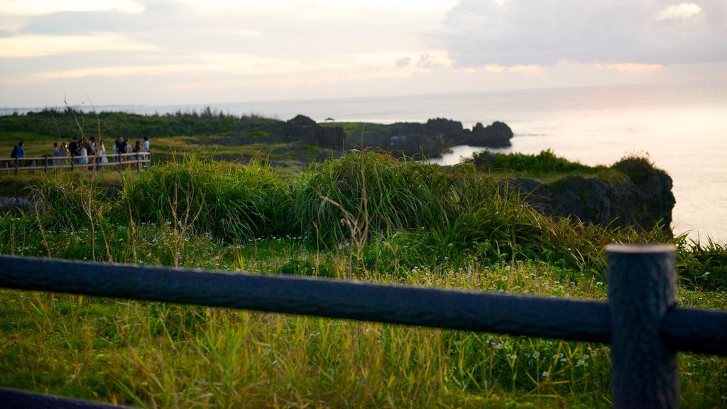 Cape Manza which includes general coastal views and a sunset