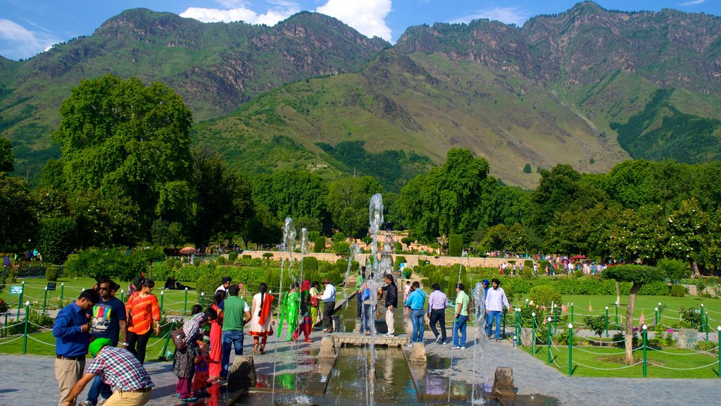 Mughal Gardens which includes a park and a fountain as well as a large group of people