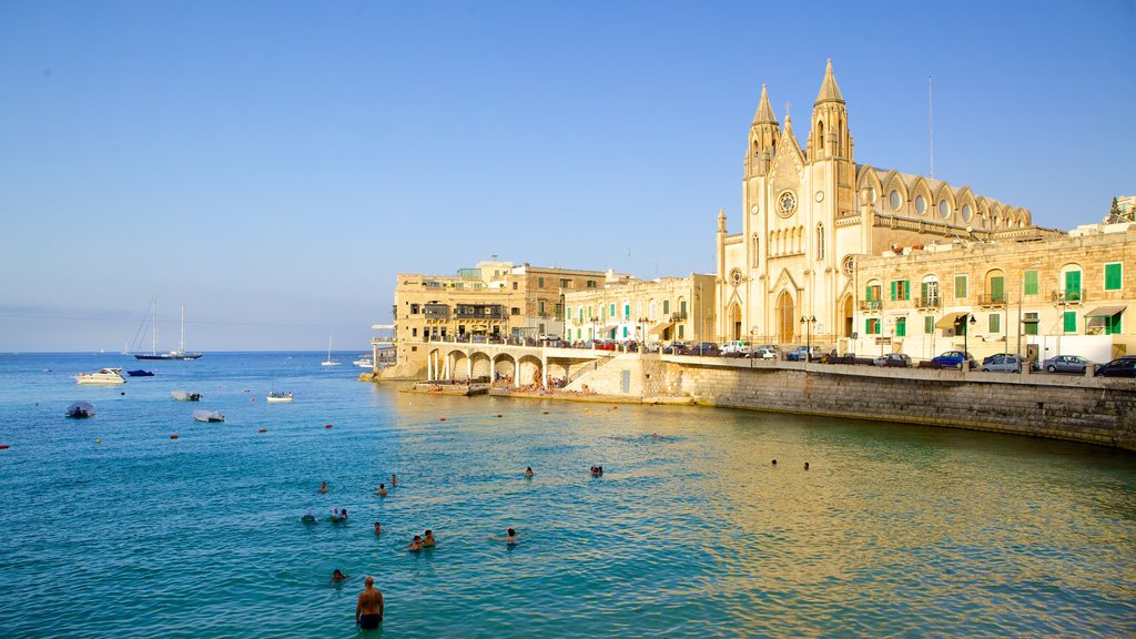 Balluta Bay featuring a coastal town, a church or cathedral and heritage architecture