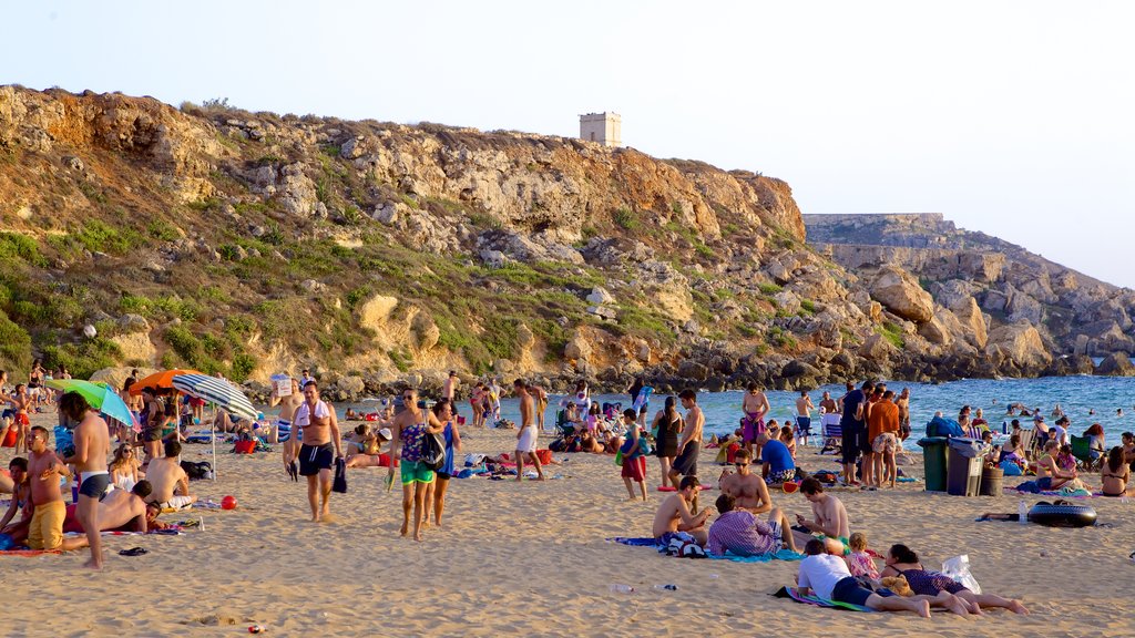 Golden Sands Beach showing a beach as well as a large group of people