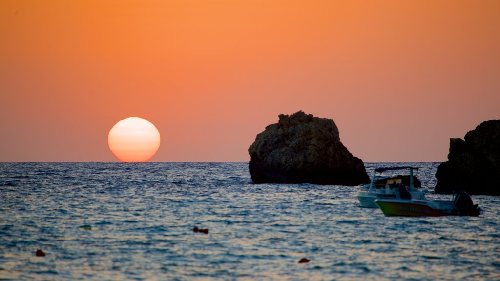 Golden Sands Beach showing rugged coastline and a sunset