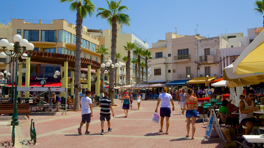 Bugibba Beach which includes street scenes, a city and outdoor eating