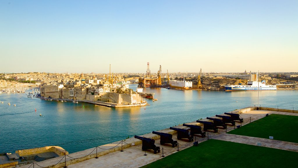 Upper Barrakka Gardens featuring military items, a coastal town and general coastal views