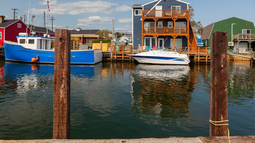 Fisherman\'s Cove which includes a bay or harbour and a house