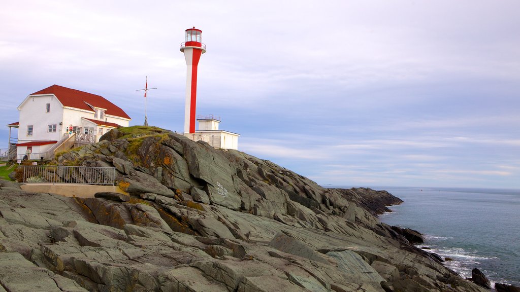 Cape Forchu Lightstation featuring a lighthouse and rocky coastline