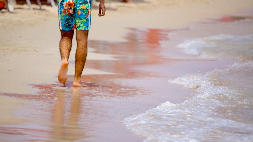 Porto Istana showing a sandy beach as well as an individual male