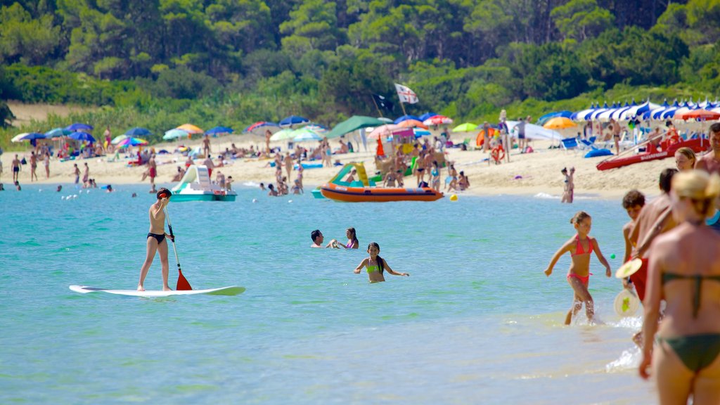 Cala Sinzias featuring a sandy beach, swimming and water sports