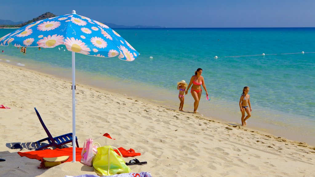 Cala Sinzias showing a beach as well as a family