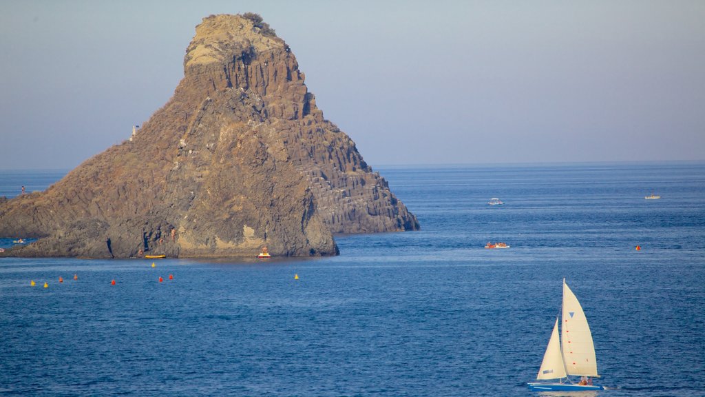 Aci Castello featuring rugged coastline and island views