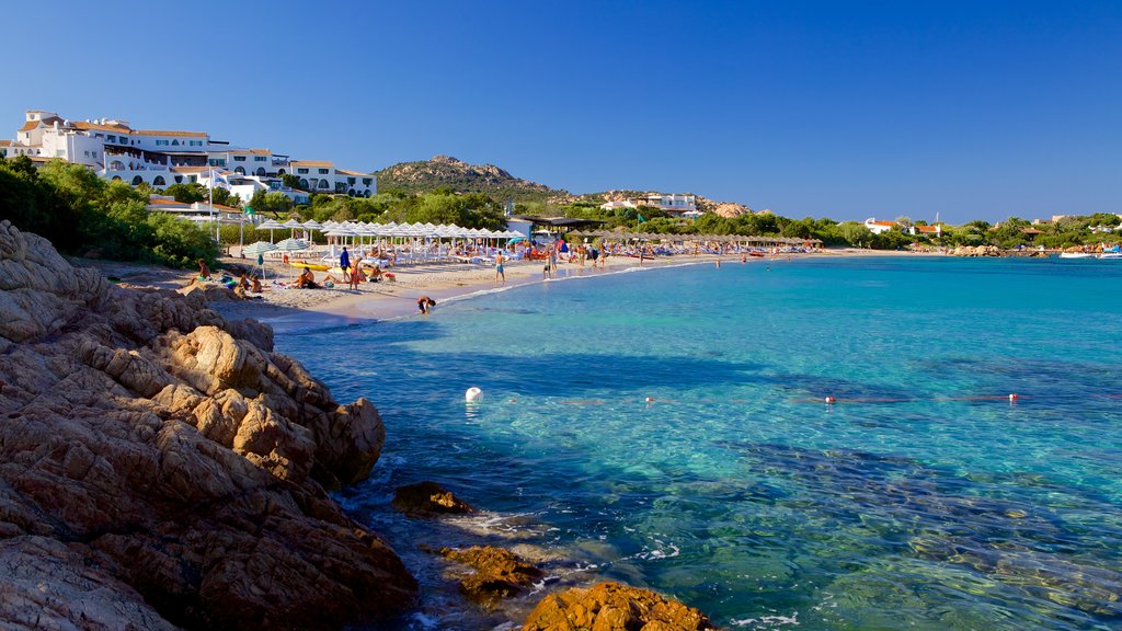 Romazzino Beach featuring a sandy beach and rocky coastline