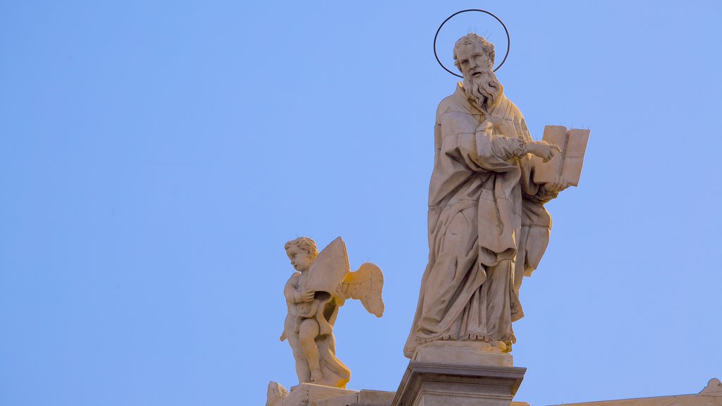 Catania Cathedral which includes a statue or sculpture, a church or cathedral and religious aspects