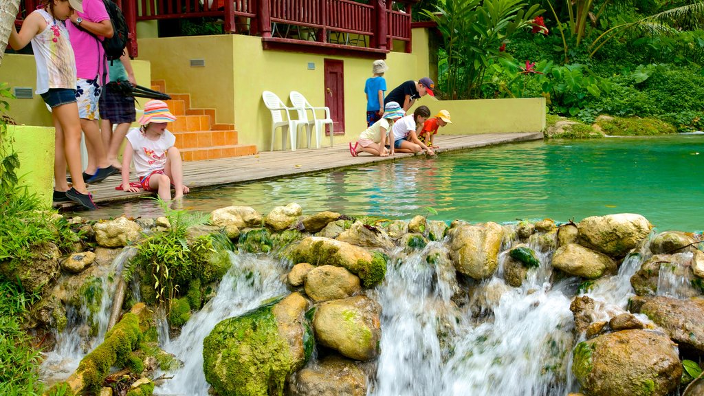 Mele Cascades which includes a river or creek as well as children